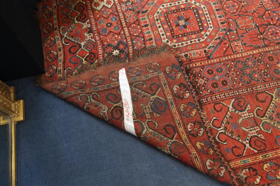 A large Persian carpet, 20ft 8in by 8ft 6in.